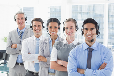 Business people with headsets smiling at camera Business people with headsets smiling at camera