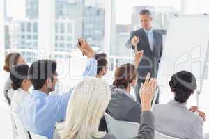 Business people raising their arms during meeting