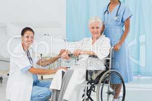 doctors and patient in wheelchair