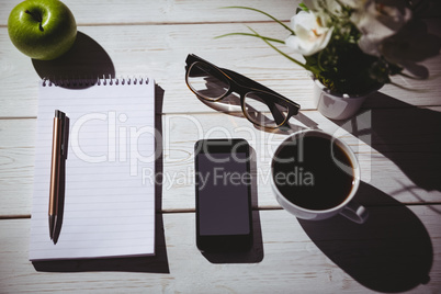 Overhead shot of notepad and smartphone