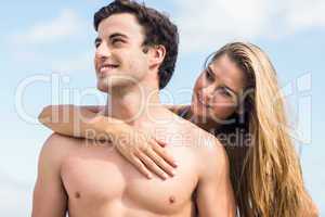 Happy couple in swimsuit embracing