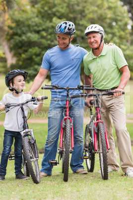 Happy multi generation family on their bike at the park