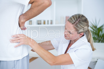 Doctor examining her patient back