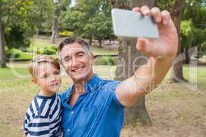 Happy father taking a selfie with his son