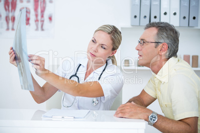 Doctor showing X rays to her patient