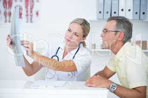 Doctor showing X rays to her patient