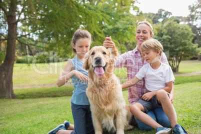 Happy family playing with their dog