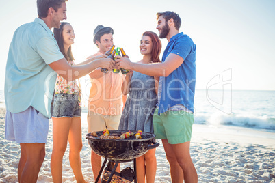 Happy friends doing barbecue and drinking beer