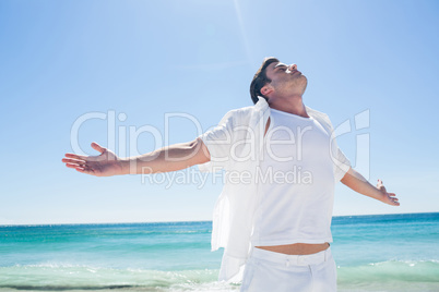 Man stretching his arms in front of the sea