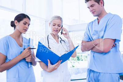 Team of doctors looking at folder