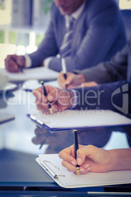 Business team taking notes at meeting