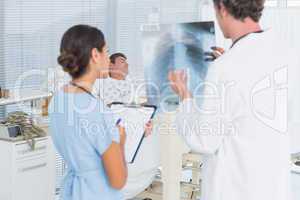 Doctors checking patients xray