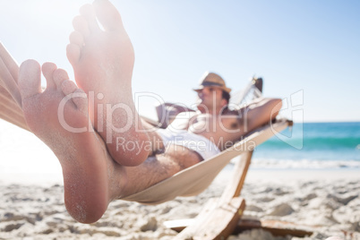 Handsome man resting in the hammock