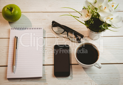 Overhead shot of notepad and smartphone