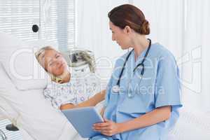 Doctor showing tablet to her patient