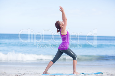 Brunette doing yoga on exercise mat