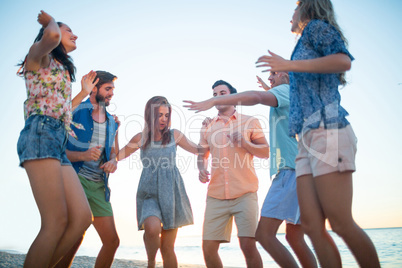 Happy friends dancing on the sand Happy friends dancing on the sand