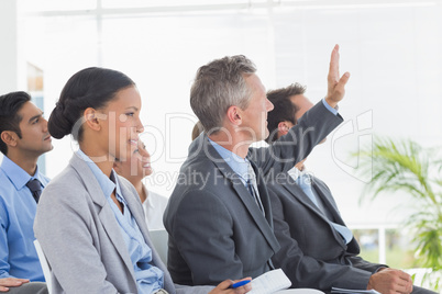 Businessman asking question during meeting