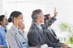 Businessman asking question during meeting