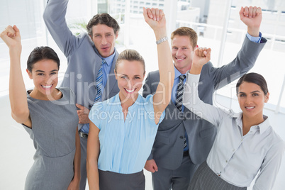 Excited business team cheering at camera