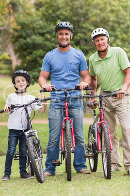 Happy multi generation family on their bike at the park