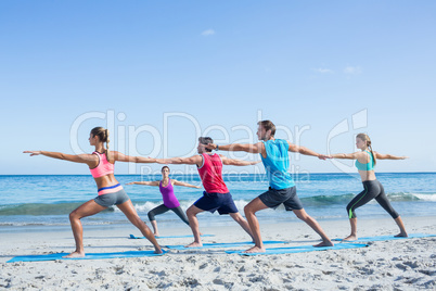 Friends doing yoga together with their teacher