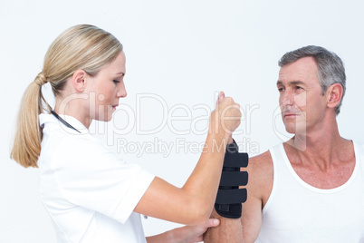 Doctor examining a man wrist