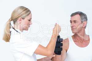 Doctor examining a man wrist