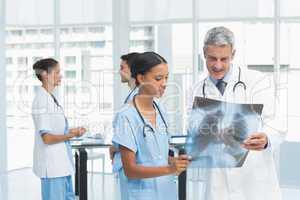 Male and female doctors examining x-ray