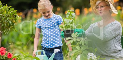 Happy grandmother with her granddaughter gardening