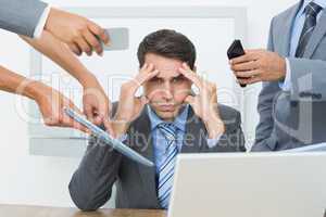 Worried businessman with head in hands