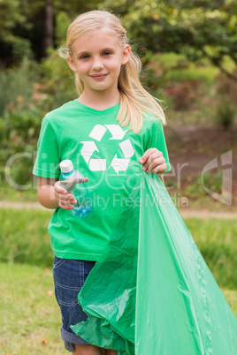 Happy little girl collecting rubbish