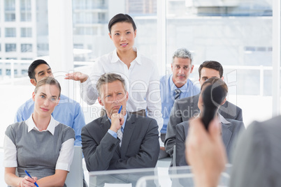 Businesswoman asking question during meeting