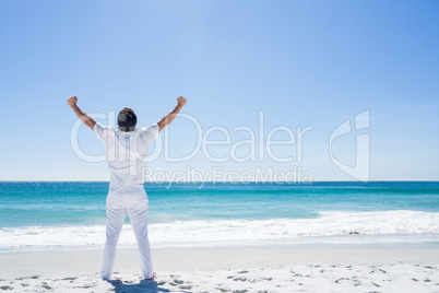 Man stretching his arms in front of the sea