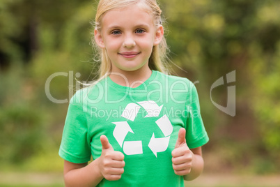 Happy little girl in green with thumbs up