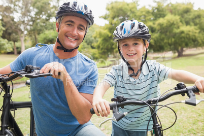 Happy father on a bike with his son