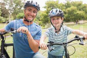 Happy father on a bike with his son