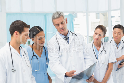 Male and female doctors examining x-ray