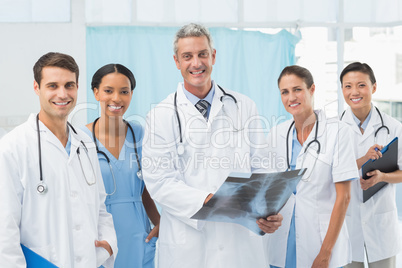 Male and female doctors examining x-ray