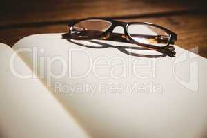 Empty notepad with reading glasses