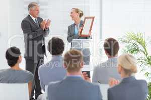 Pretty businesswoman receiving prize