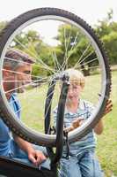 Father and his son fixing a bike