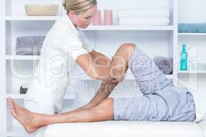 Physiotherapist doing calf massage to her patient