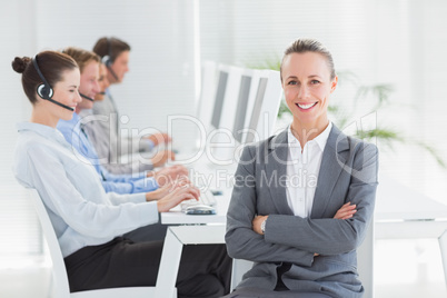 Manager smiling at camera with her staff behind