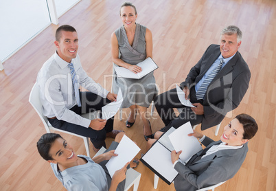 Business team sitting in circle and discussing