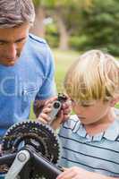 Father and his son fixing a bike