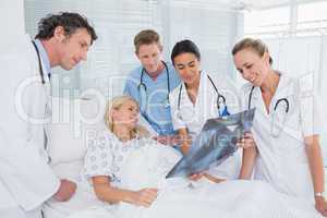 Smiling doctors showing xray to patient