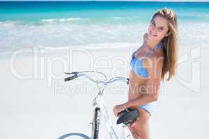 Pretty blonde woman going on a bike ride