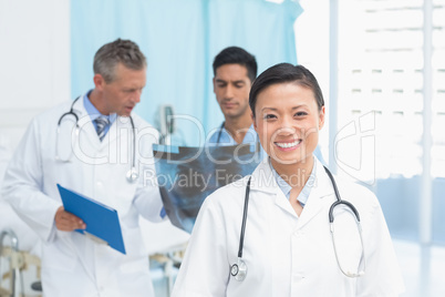 Male and female doctors examining x-ray