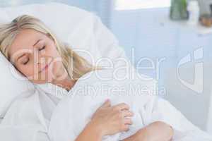 Happy patient lying on her bed